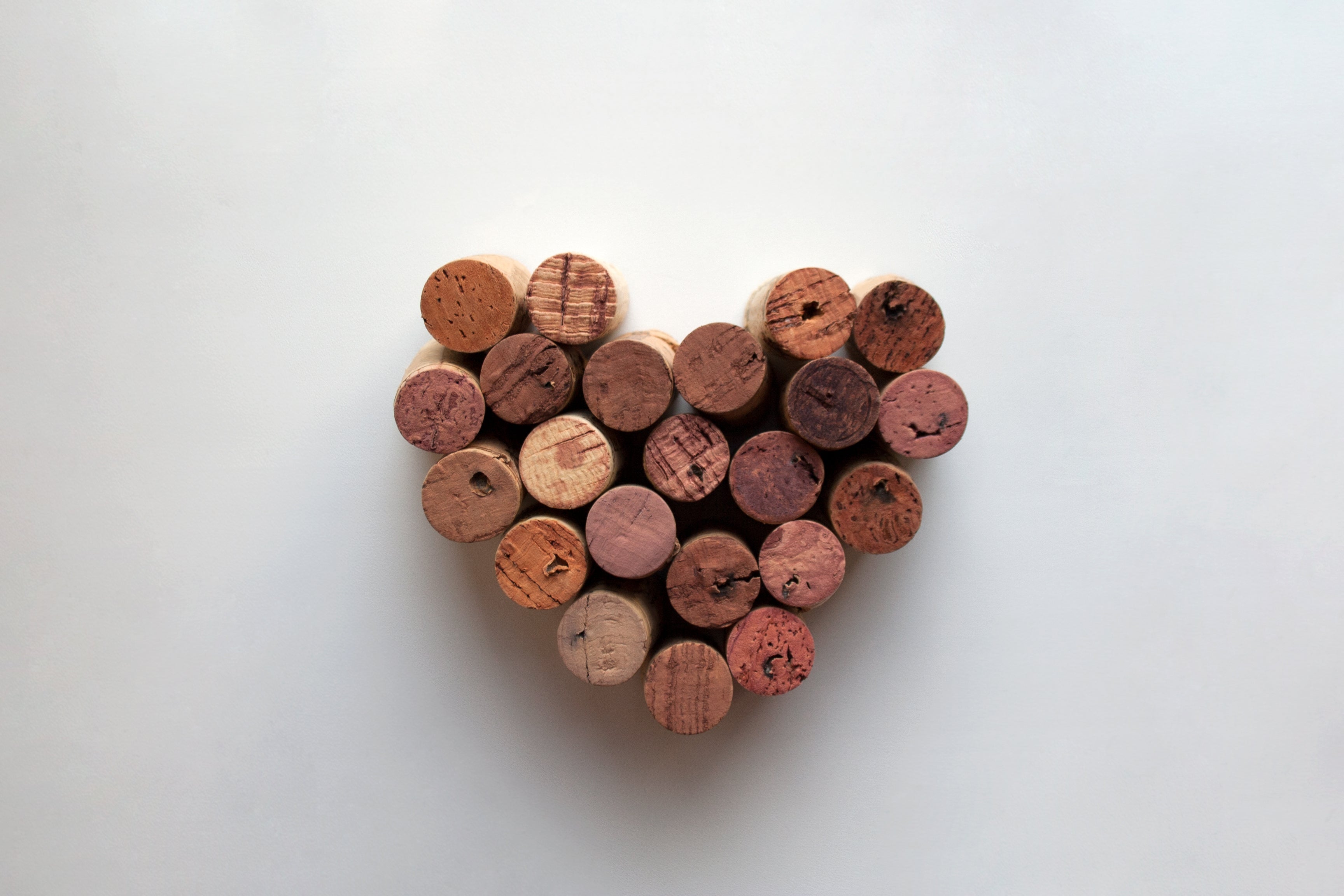 wine corks in love heart shape on white background